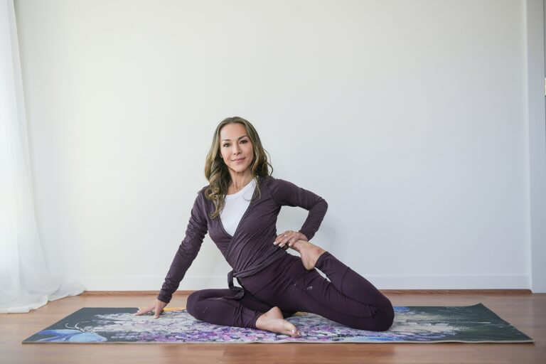 Woman practicing yoga seated twist pose indoors